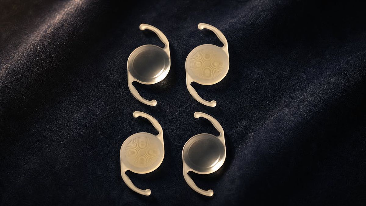 Four intraocular lens implants arranged in a grid on navy velvet